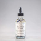 Crystal Irie Tea Tree Serum in a sleek bottle, showcasing the clear serum with tea tree leaves in the background.