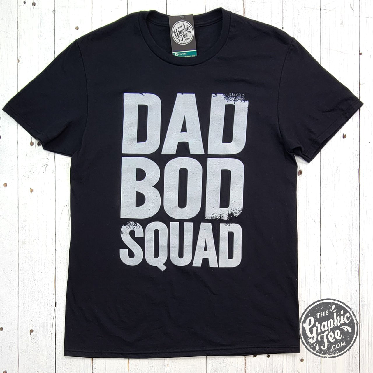 Black ink Dad Bod Squad graphic T-shirt by The Graphic Tee, short sleeve design with bold print on soft fabric.