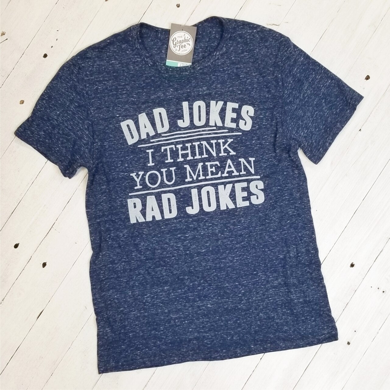 Adult graphic T-shirt from The Graphic Tee featuring humorous dad jokes, casual short-sleeve design, and playful print.