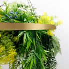 Artificial hanging plant chandelier with tropical foliage and draping stems in a gold frame, UV resistant for outdoor decor.