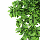 Artificial dense flowering Pothos hanging bush by Designer Plants USA, UV resistant, fire-rated, with lush green leaves and vibrant blooms.