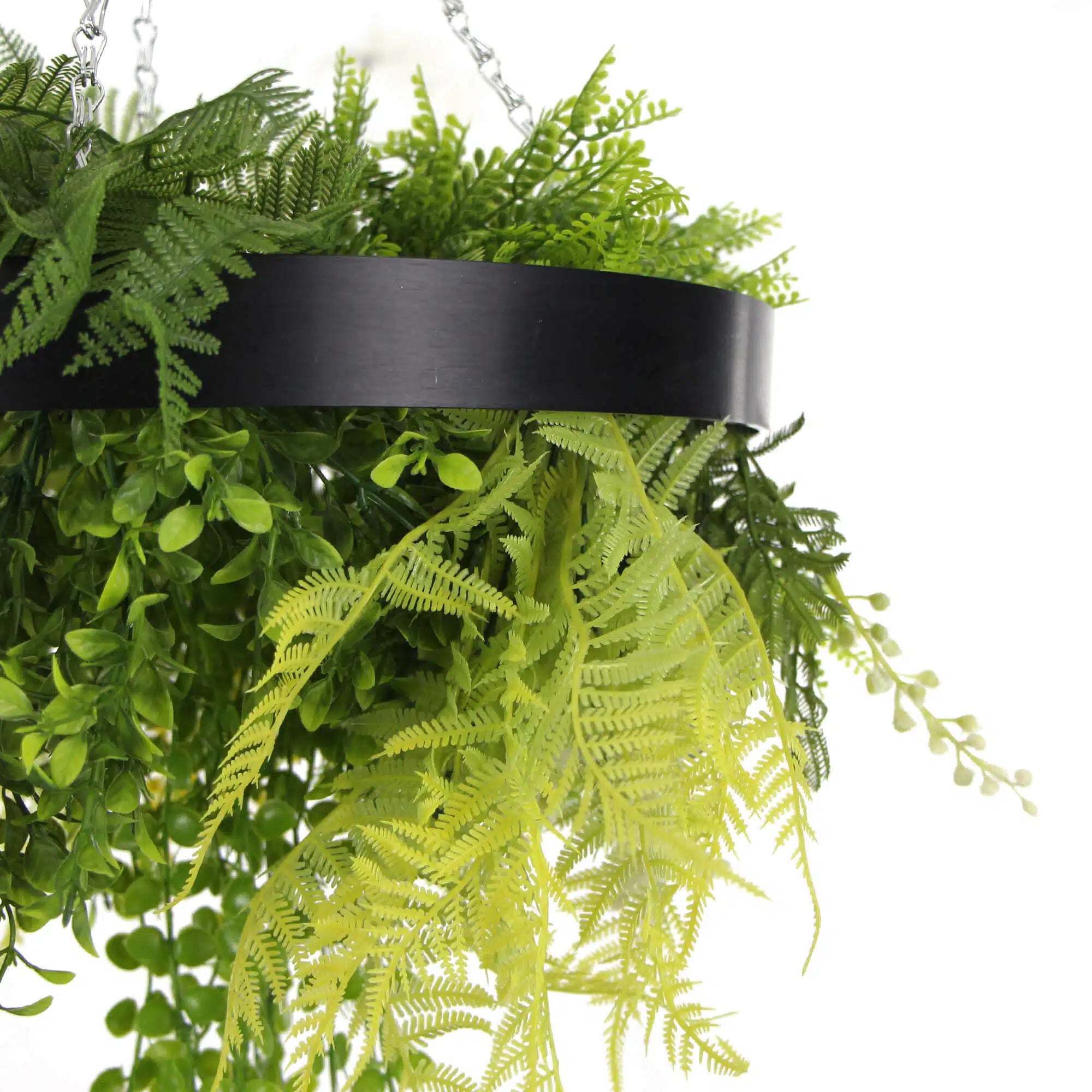 Black-framed 25-inch artificial hanging plant disc with draping faux ferns, UV resistant for roof or wall decor.