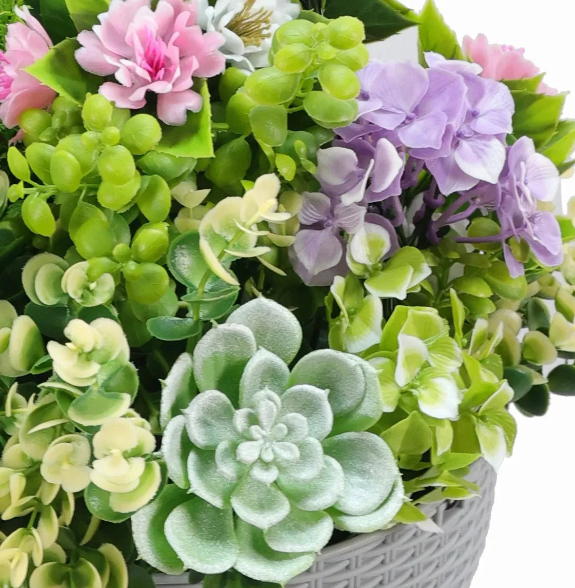 Close-up of Designer Plants USA 14-inch UV-resistant artificial succulent hanging basket showing realistic green succulents in a basket.