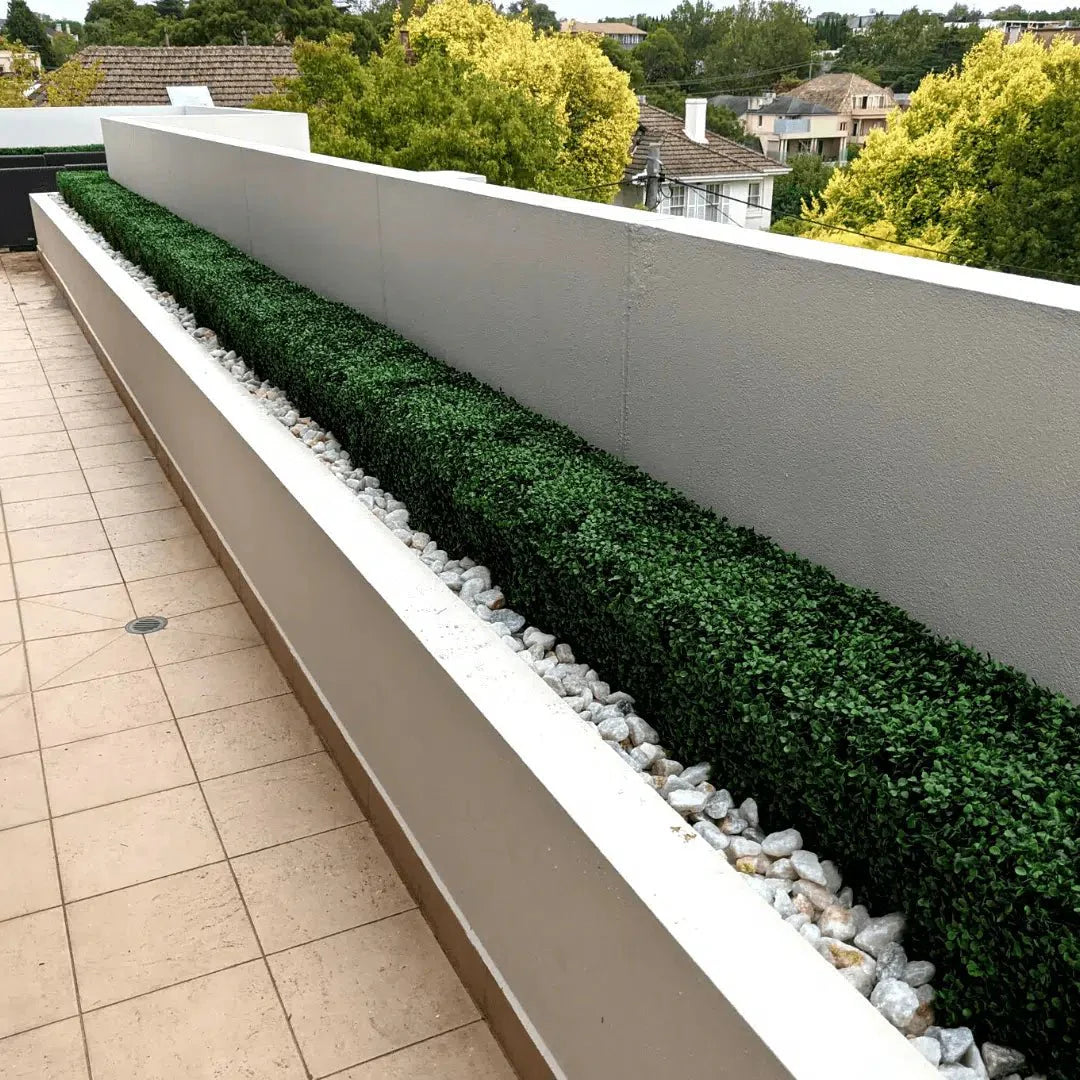 Artificial boxwood hedge by Designer Plants USA, 40x10 inches, UV resistant, perfect for outdoor borders or decorative landscaping.