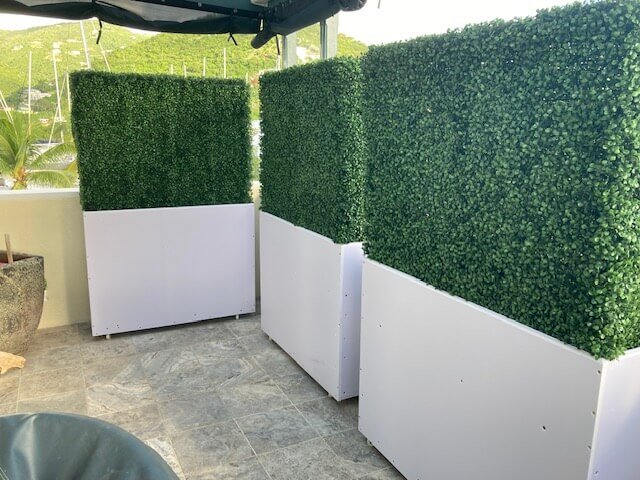 Two-tone green artificial boxwood hedge in white planters, UV resistant, commercial grade, suitable for outdoor landscaping.