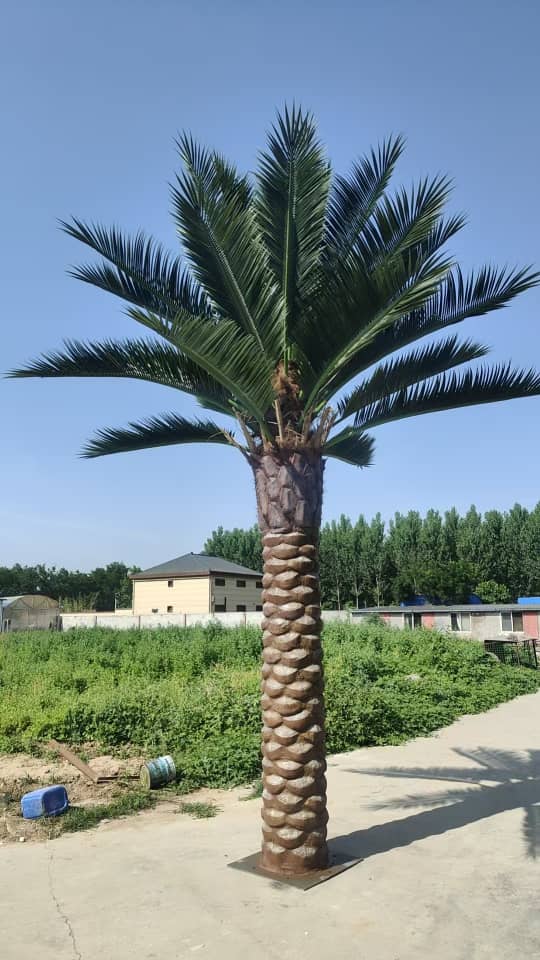 13ft to 23ft Florida Palm artificial tree by Designer Plants USA with UV-resistant material, shown in a lush outdoor setting.