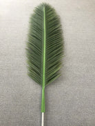Giant artificial palm leaf from Designer Plants USA's 13ft to 23ft UV-resistant artificial palm tree.