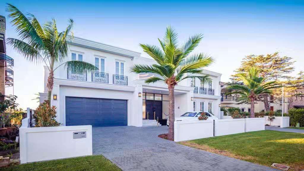 Elegant 13 to 23-foot UV-resistant artificial palm tree by Designer Plants USA installed at a luxury home.