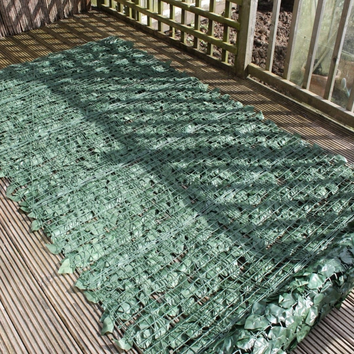 Artificial ivy privacy fence roll by Designer Plants USA, showing the trellis backing and lush green faux ivy for outdoor privacy.