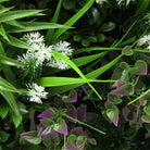 Close-up of Amazon Jungle artificial vertical garden panel with lush, vista-like green leaves, UV resistant for commercial wall installation