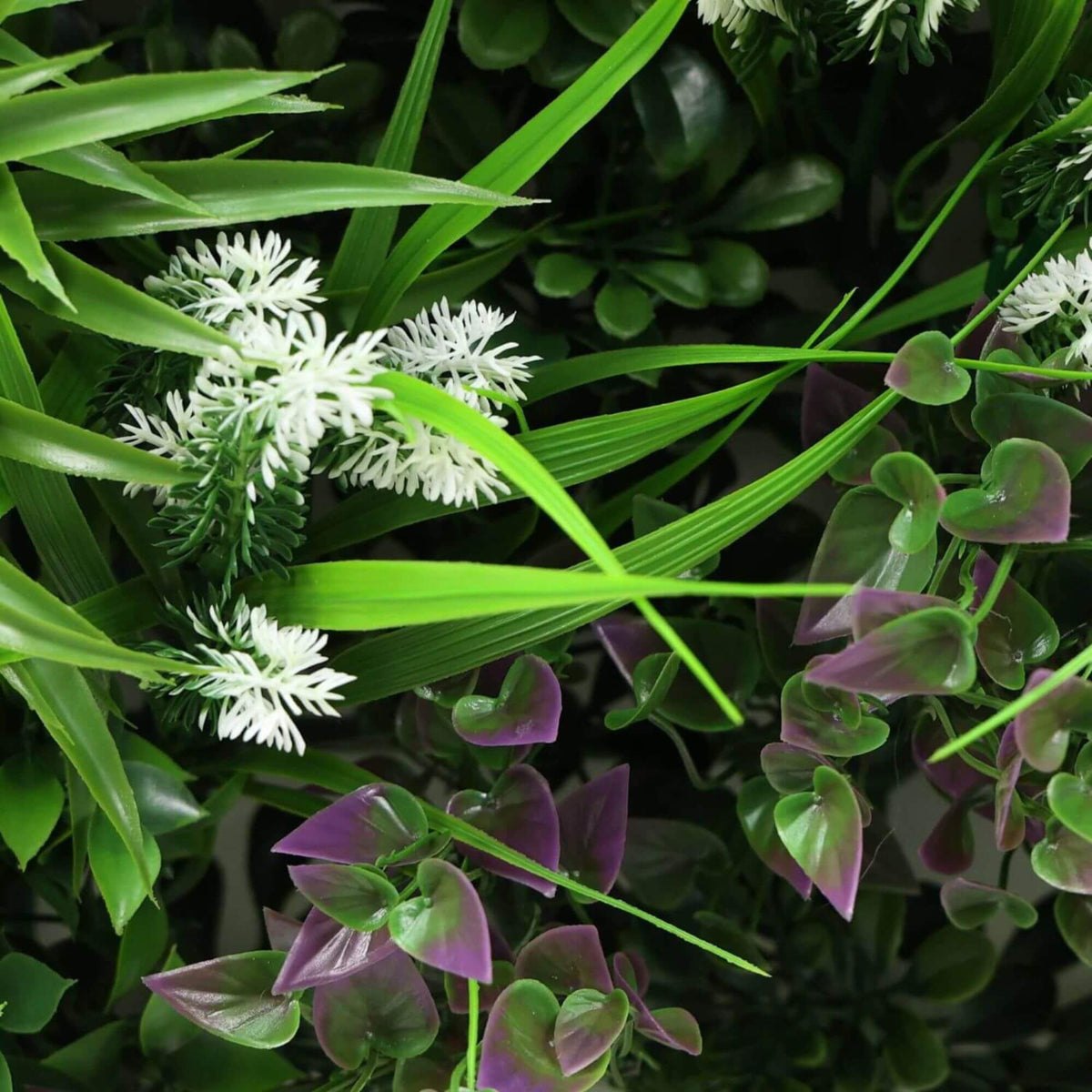 Close-up of Amazon Jungle artificial vertical garden panel with lush, vista-like green leaves, UV resistant for commercial wall installation