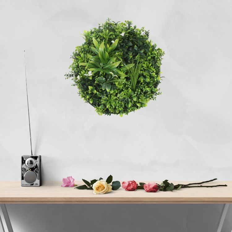 Artificial green wall disc with white frame from Designer Plants USA, UV resistant living wall with potted plants for commercial use.