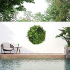Artificial green wall disc with black frame, UV resistant, commercial-grade living wall featuring lush potted plants by Designer Plants USA.