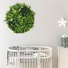 Artificial green wall disc with black frame, UV resistant, commercial grade living wall from Designer Plants USA, ideal for modern interiors.