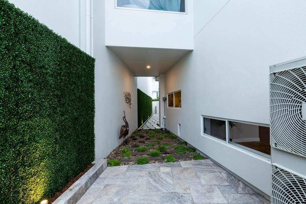 Artificial boxwood green wall panel by Designer Plants USA, 10ft x 3.3ft UV-resistant living wall coverage for commercial spaces.