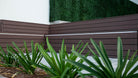 Dark boxwood artificial vertical garden wall panel by Designer Plants USA, UV resistant living wall for commercial or indoor use.