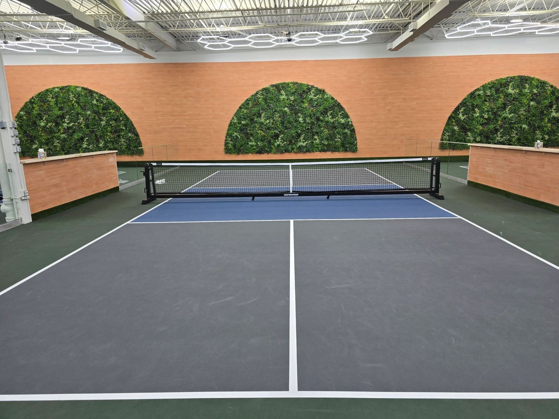 Artificial vertical garden panels by Designer Plants USA, faux green wall for indoor tennis courts, UV resistant, 33 sq ft.