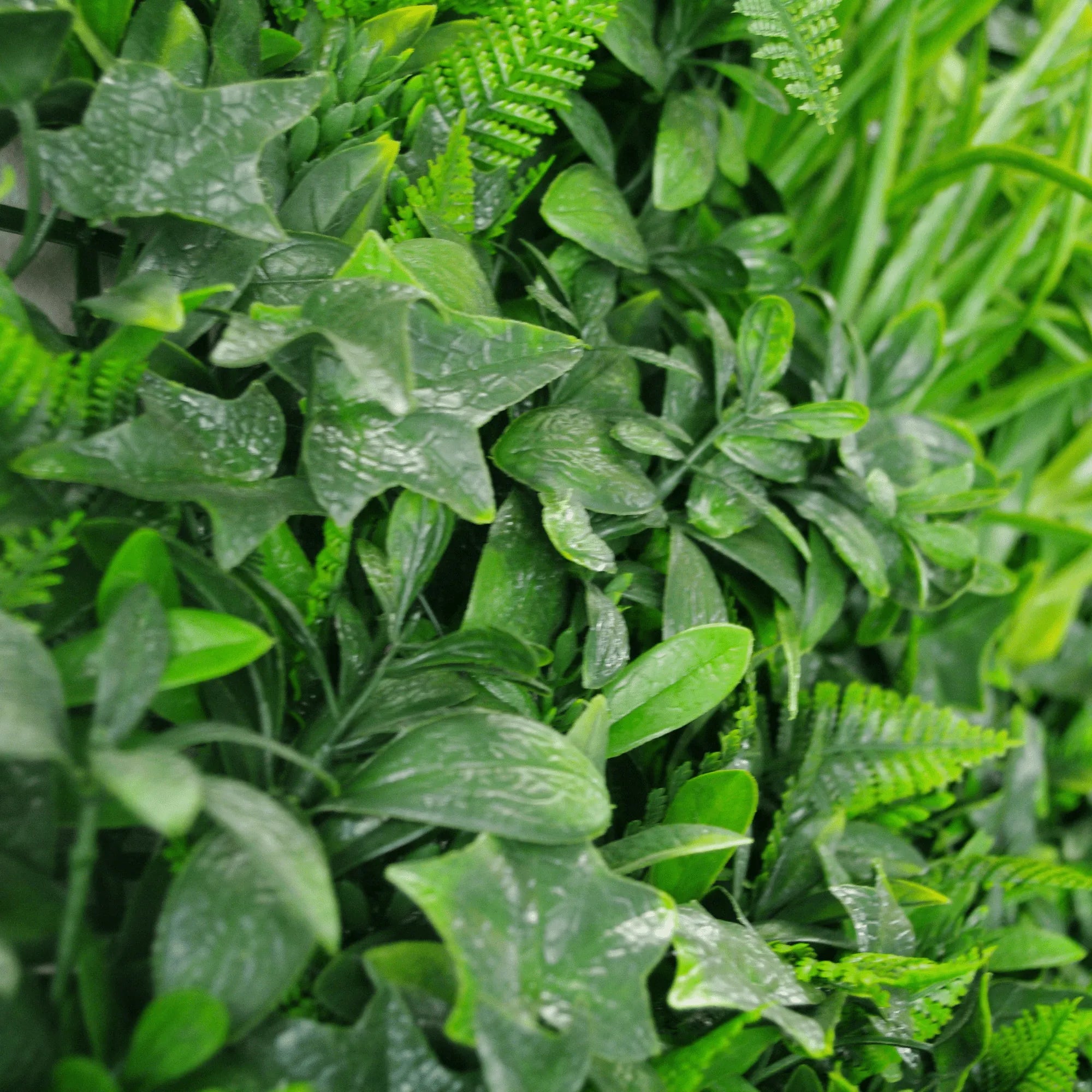 Green Tropics artificial vertical garden panel by Designer Plants USA, UV resistant living wall with lush green foliage in 40x40 inch size