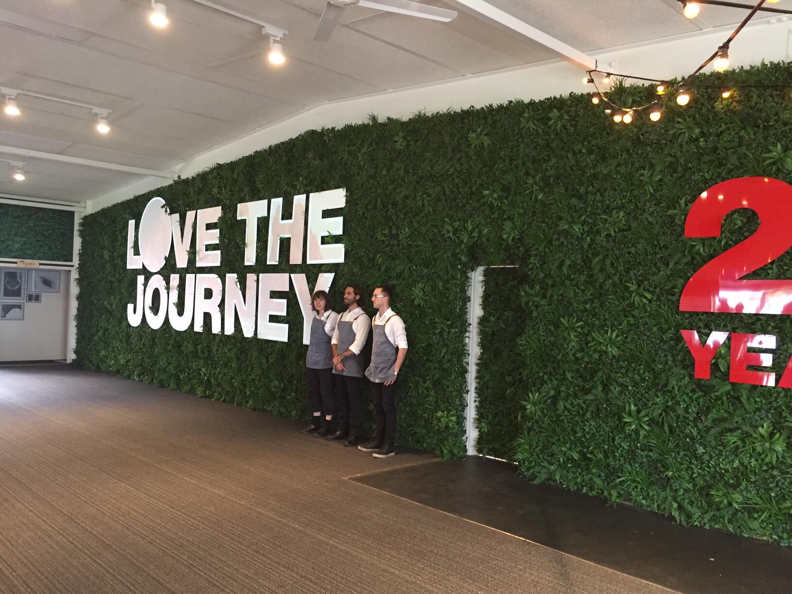 Green Tropics artificial vertical garden panel by Designer Plants USA, UV-resistant living wall with lush green foliage, 40x40 inches.
