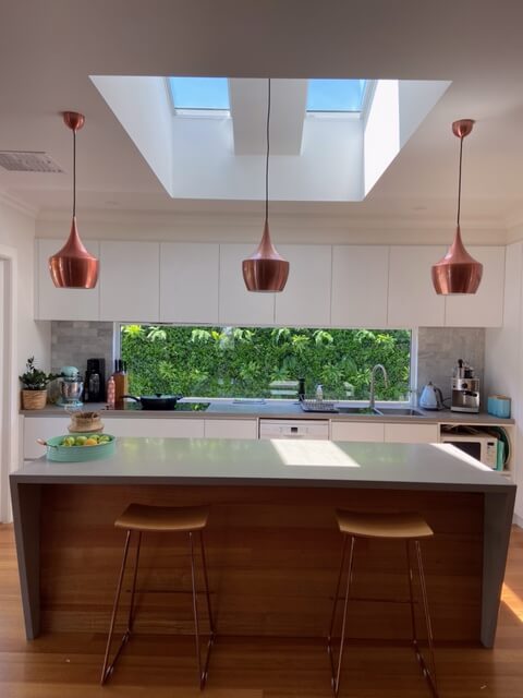 Artificial green wall panel by Designer Plants USA, 40x40 inch vertical garden with UV-resistant living wall panels in a kitchen setting.