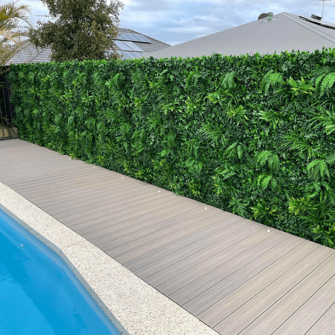 Green Tropics artificial vertical garden green wall panel by Designer Plants USA in a pool area, UV resistant, 40x40 inches, commercial grade