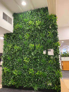 Artificial green wall panel by Designer Plants USA, 40x40 inch living wall with UV-resistant, lush tropical foliage for commercial use.