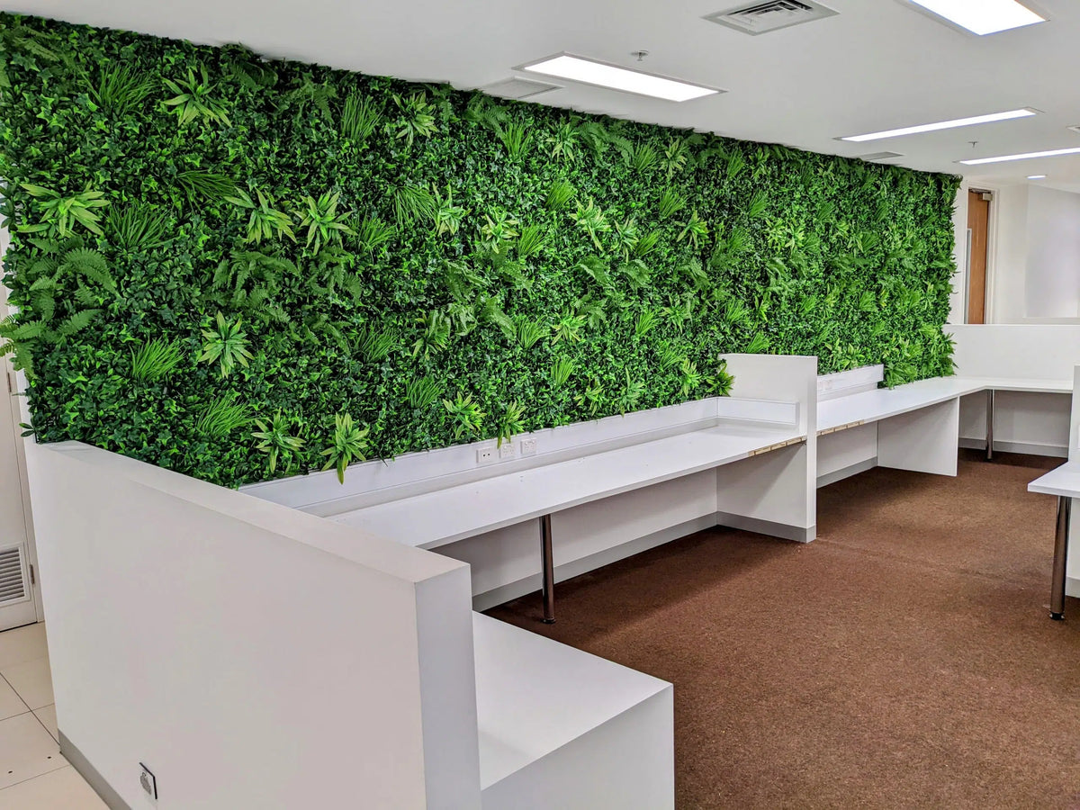Artificial green wall panel by Designer Plants USA, installed as a living wall in an office setting, UV resistant, 40x40 inches.