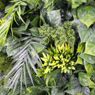 Close-up of Hawaiian Sunrise flowering artificial green wall panel with lush palm leaves and vibrant flowers, UV resistant for living walls.