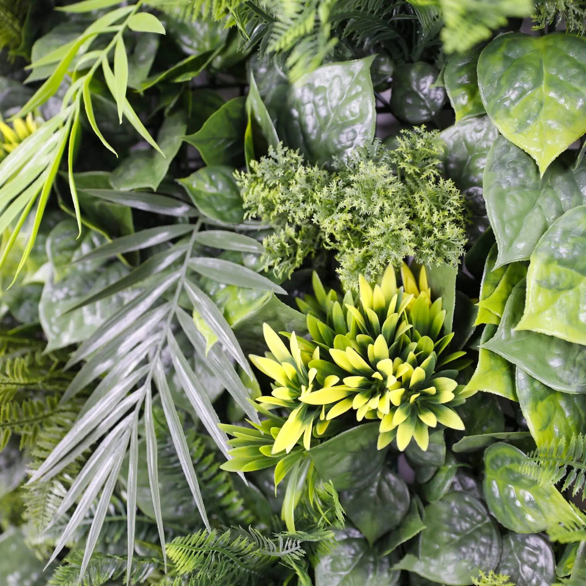 Close-up of Hawaiian Sunrise flowering artificial green wall panel with lush palm leaves and vibrant flowers, UV resistant for living walls.