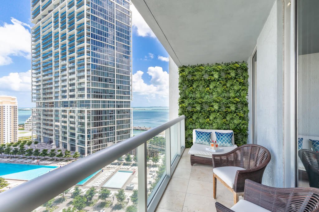 Artificial Hawaiian Sunrise flowering green wall panel from Designer Plants USA, UV resistant living wall for commercial and balcony use.