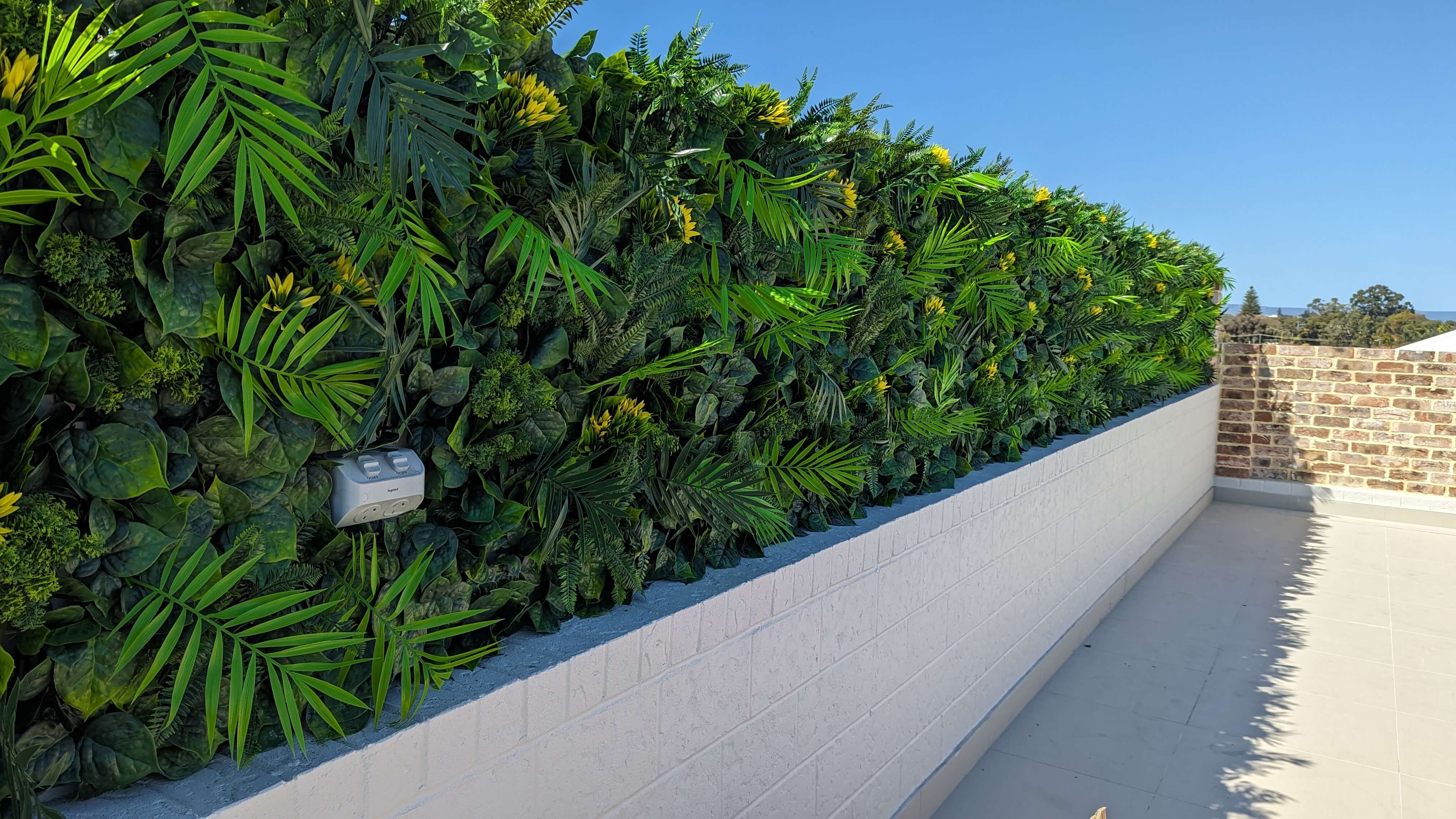 Artificial Hawaiian Sunrise flowering green wall panel with yellow flowers, UV resistant, 40x40 inch vertical garden by Designer Plants USA