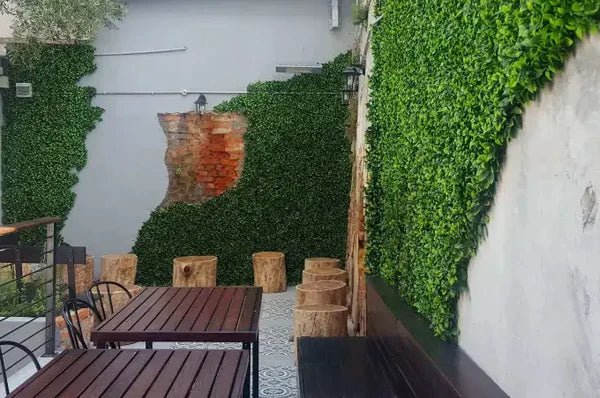 Artificial jasmine green wall panel with ivy and hedge shapes, UV resistant, commercial-grade vertical garden by Designer Plants USA.