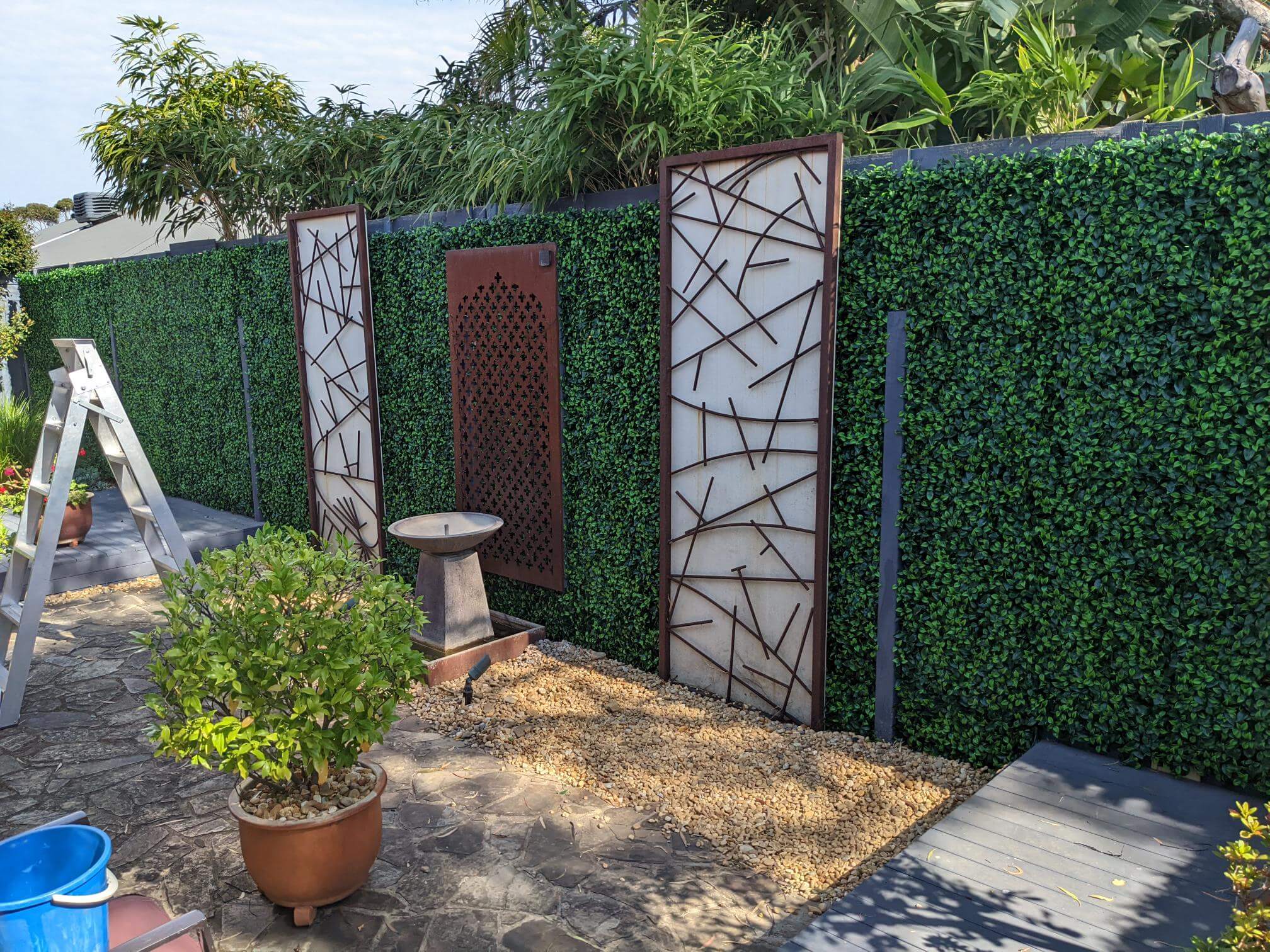 Artificial jasmine green wall panel by Designer Plants USA, 40x40 inch vertical garden with UV-resistant, lush faux ivy for living walls.