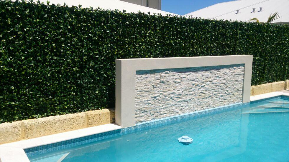 Artificial green wall panel from Designer Plants USA, 40x40 inch living wall for pool fence, UV resistant, commercial grade.