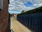 Artificial green wall panel by Designer Plants USA, 40x40 inch lush vertical garden on a fence for commercial or residential use.