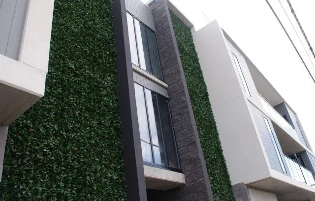 Photinia artificial vertical garden wall panel by Designer Plants USA, UV resistant living wall with lush green foliage, 40x40 inches.