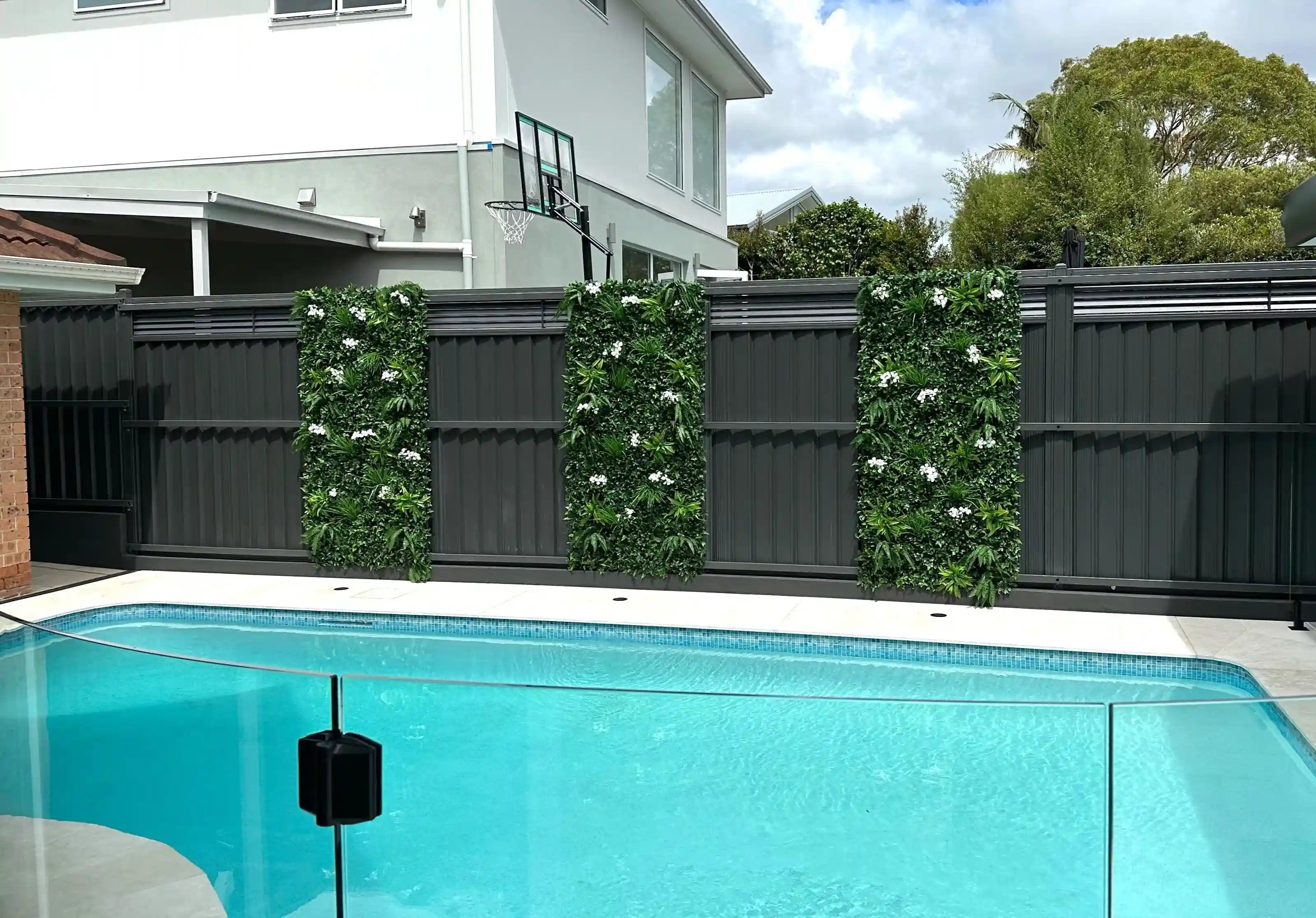 Artificial white-flowered vertical garden wall panel by Designer Plants USA, UV resistant living wall for commercial or residential use.