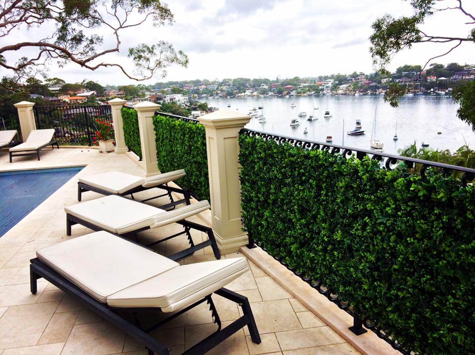 Artificial vertical garden panel by Designer Plants USA, green wall with lush faux ivy and hedge for commercial or home use.