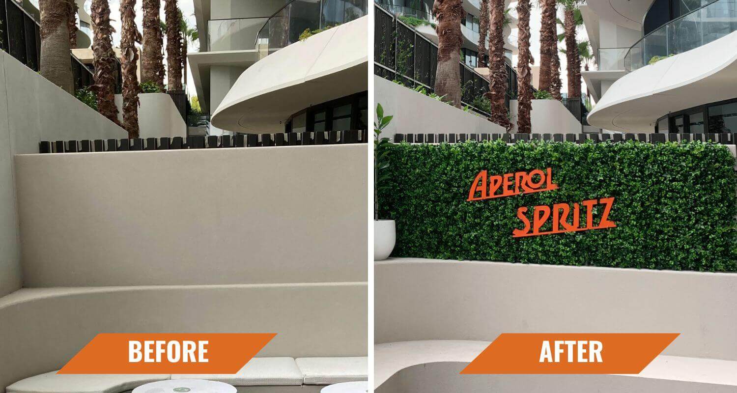 Vertical garden panel by Designer Plants USA installed on concrete wall, showcasing lush green artificial living wall for commercial spaces.