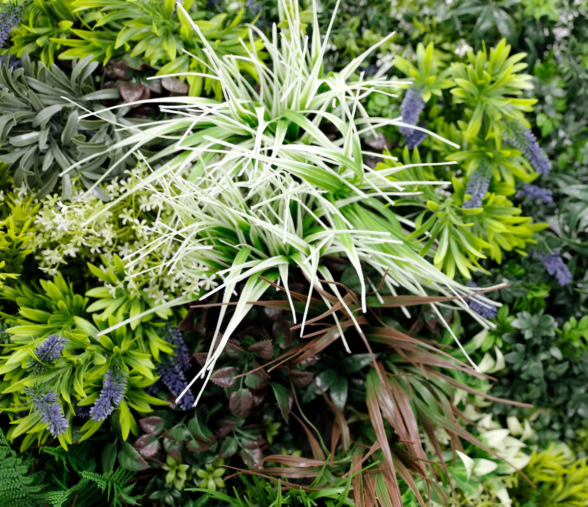 Closeup of tropical forest artificial greenery wall panel with white grass detail, designed for living walls by Designer Plants USA.