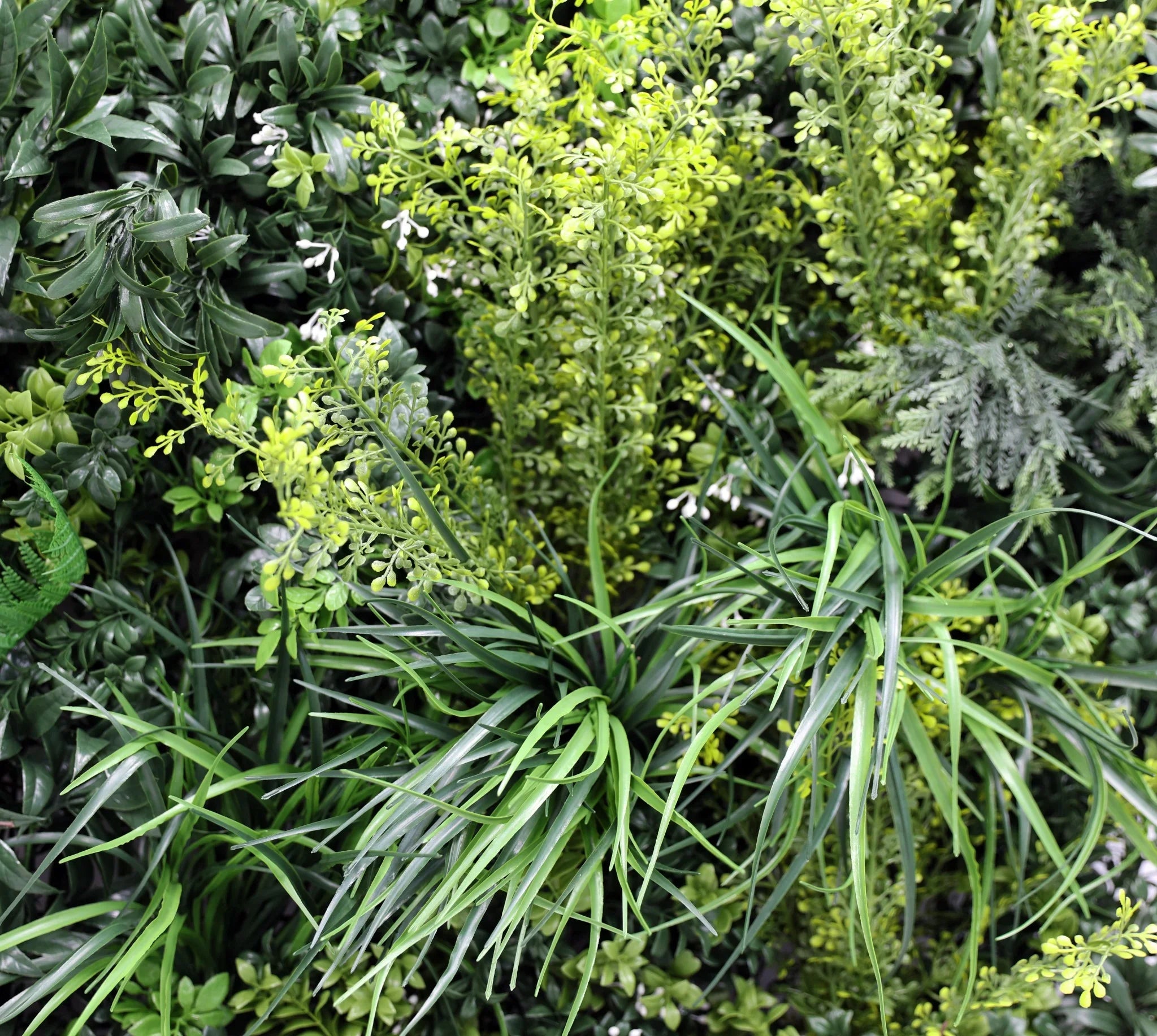 Realistic tropical vibe artificial vertical garden panel from Designer Plants USA, 35x35in, UV resistant, fire-rated living wall.