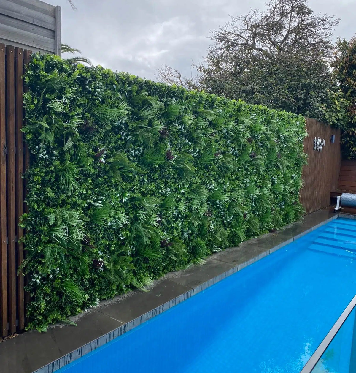 Artificial tropical Vista vertical garden panel by Designer Plants USA, UV resistant green wall with lush foliage, 40x40 inches.