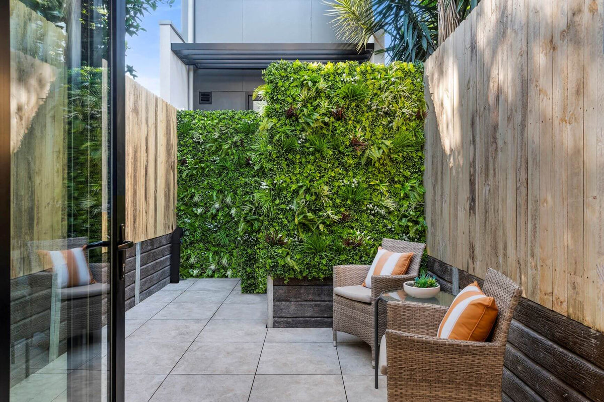 Vertical garden panel by Designer Plants USA, tropical-style artificial green wall with UV-resistant foliage, 40x40 inches.
