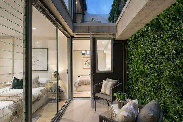 White Oasis artificial vertical garden wall panel by Designer Plants USA, UV resistant living wall for commercial or indoor use.