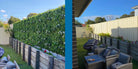 Artificial white oasis vertical garden wall panel by Designer Plants USA, showing before and after installation of a UV-resistant living wall.