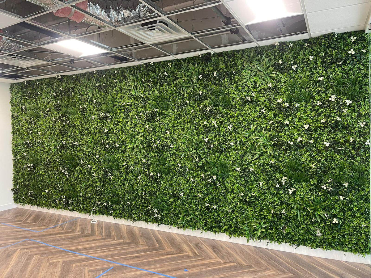 White Oasis artificial vertical garden panel installed in a Miami law office, showcasing a lush, UV-resistant living wall by Designer Plants USA.