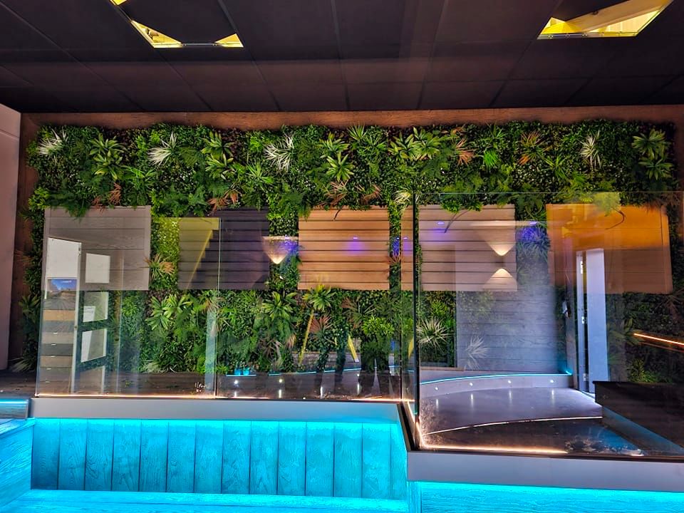 Artificial green wall panel from Designer Plants USA, installed in a business reception area, UV resistant, 40x40 inch living wall.