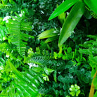 Wild Tropics artificial vertical garden wall panel by Designer Plants USA, UV resistant living wall with lush green foliage.