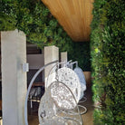 Small sample panel of Designer Plants USA's Lush Spring Vertical Garden showing a green wall with lush faux plants in a hotel setting.
