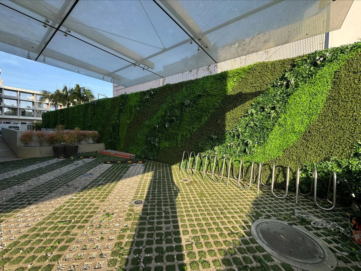 Small sample of Designer Plants USA natural boxwood green wall panel, showcasing lush, realistic greenery for interior or exterior décor.